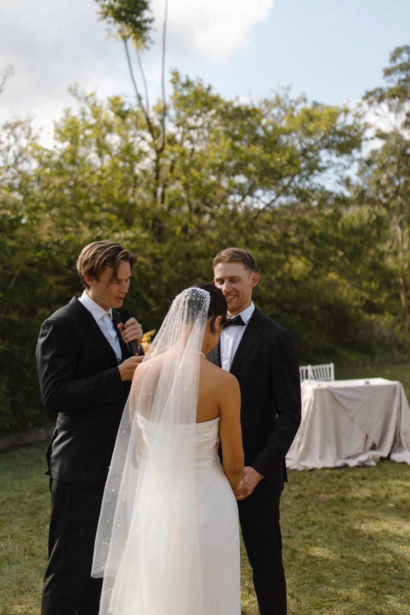 Brayden sharing a quiet moment with the couple mid-ceremony