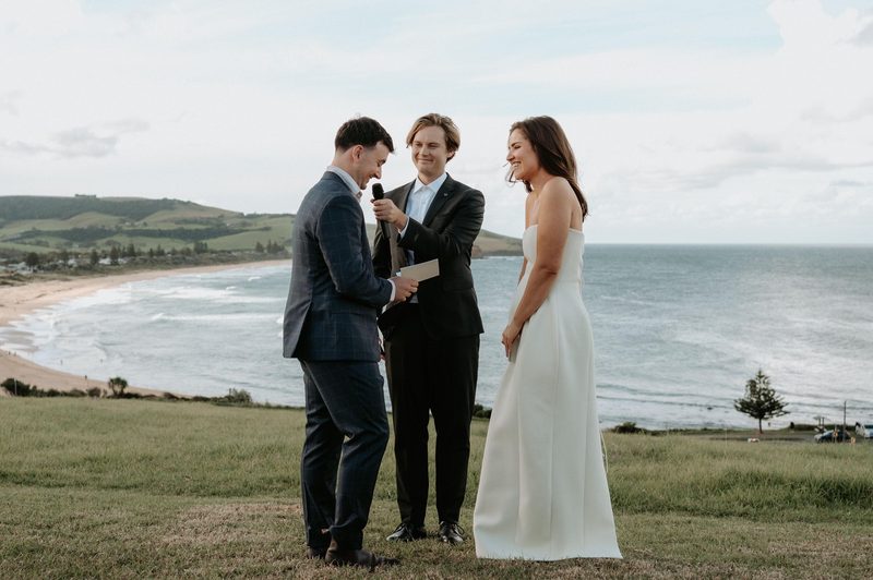 Clifftop vows above a sweeping beach panorama