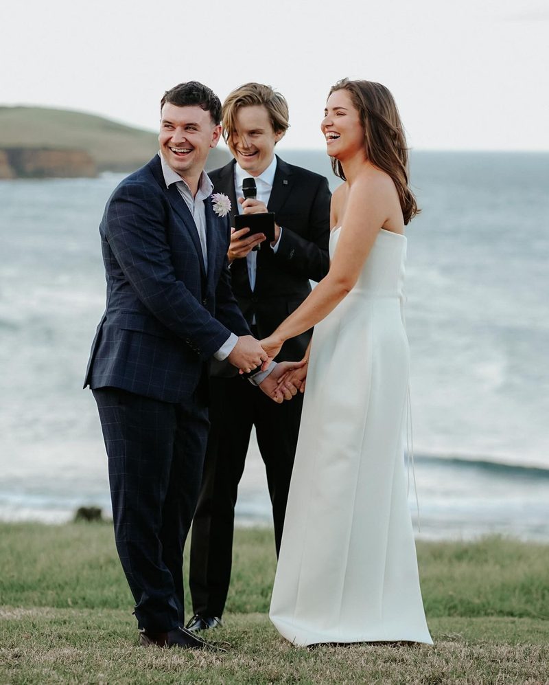 Couple and Brayden laughing together by the ocean